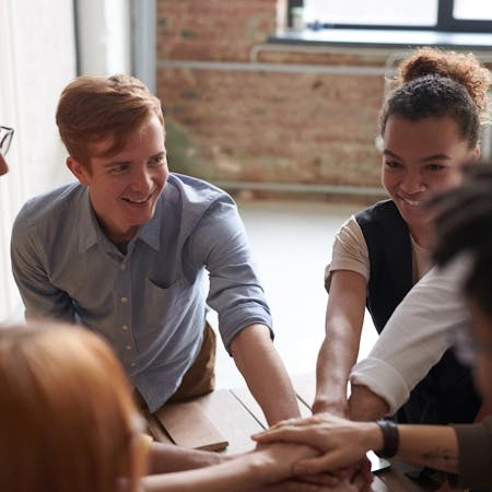 A support group for alcoholism meets in a medium sized brick room.